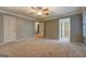 Large bedroom with carpet, featuring views into bathroom and closet at 308 Tulipwood Sw Cir, Conyers, GA 30094