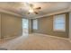 Spacious bedroom featuring neutral walls, carpet, ceiling fan, and natural light from windows at 308 Tulipwood Sw Cir, Conyers, GA 30094