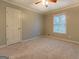 Bedroom with neutral walls and carpet, a ceiling fan, and a window at 308 Tulipwood Sw Cir, Conyers, GA 30094