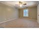 Large bedroom with neutral walls, carpet, and a ceiling fan and a bright window at 308 Tulipwood Sw Cir, Conyers, GA 30094