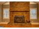 A full view of the brick fireplace in the living room complete with firebox and mantle at 308 Tulipwood Sw Cir, Conyers, GA 30094