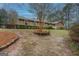 Lovely exterior view featuring a brick facade, red shutters, and a mature tree enhancing curb appeal at 308 Tulipwood Sw Cir, Conyers, GA 30094