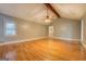 An airy living room boasts hardwood floors, vaulted ceiling with fan, and a large window at 308 Tulipwood Sw Cir, Conyers, GA 30094