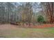 Fenced swimming pool, surrounded by mature trees, offering a private and serene backyard oasis at 308 Tulipwood Sw Cir, Conyers, GA 30094