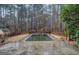 In-ground swimming pool with a large concrete patio, surrounded by lush greenery, perfect for summer enjoyment at 308 Tulipwood Sw Cir, Conyers, GA 30094