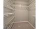 Organized walk-in closet with carpeted floor and ample metal shelving at 308 Tulipwood Sw Cir, Conyers, GA 30094