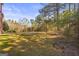 Expansive backyard with a combination of grassy areas and a wooded perimeter providing privacy at 100 Windmeadow Way, Fayetteville, GA 30214