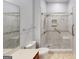 This bathroom features marble tile accents, a glass shower and modern fixtures at 100 Windmeadow Way, Fayetteville, GA 30214