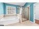 Bright bathroom featuring a soaking tub and a stand up shower at 100 Windmeadow Way, Fayetteville, GA 30214