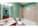 Well-lit bathroom featuring tiled shower and bathtub combination, toilet and vanity with sink at 100 Windmeadow Way, Fayetteville, GA 30214