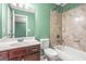 Bright bathroom features a modern vanity, toilet, and shower-tub combo with tiled surround at 100 Windmeadow Way, Fayetteville, GA 30214