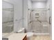 Bright bathroom featuring a tile shower, marble countertop, and a white toilet at 100 Windmeadow Way, Fayetteville, GA 30214