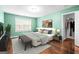 This staged bedroom offers a cozy sitting area, decorative rug, and a walk-in closet at 100 Windmeadow Way, Fayetteville, GA 30214