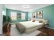 Staged bedroom with a neutral rug, sitting area and decorative artwork at 100 Windmeadow Way, Fayetteville, GA 30214