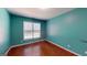 Comfortable bedroom featuring hardwood floors and a window with natural light at 100 Windmeadow Way, Fayetteville, GA 30214