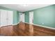 Open bedroom space with hardwood flooring and neutral paint at 100 Windmeadow Way, Fayetteville, GA 30214