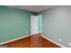 Cozy bedroom featuring hardwood floors and a door leading to another room at 100 Windmeadow Way, Fayetteville, GA 30214