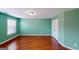 Spacious bedroom featuring hardwood floors and a window with natural light and white trim at 100 Windmeadow Way, Fayetteville, GA 30214