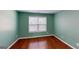 Comfortable bedroom with hardwood flooring, neutral paint and a window providing natural light at 100 Windmeadow Way, Fayetteville, GA 30214