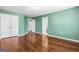 Large bedroom with hardwood floors and many doors at 100 Windmeadow Way, Fayetteville, GA 30214