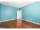 Spacious bedroom featuring wood floors and blue walls at 100 Windmeadow Way, Fayetteville, GA 30214