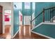 Inviting two-story foyer with hardwood floors and staircase with iron balusters at 100 Windmeadow Way, Fayetteville, GA 30214