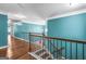 Bright hallway showcasing hardwood floors and unique banister at 100 Windmeadow Way, Fayetteville, GA 30214