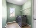 Spacious laundry room with a window and modern washer and dryer at 100 Windmeadow Way, Fayetteville, GA 30214