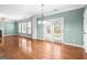 Bright living room has hardwood floors and French doors leading to the outside at 100 Windmeadow Way, Fayetteville, GA 30214