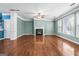 Bright living room features a fireplace, large windows, and hardwood floors at 100 Windmeadow Way, Fayetteville, GA 30214