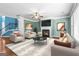 Cozy living room with fireplace, ceiling fan, and comfortable seating at 100 Windmeadow Way, Fayetteville, GA 30214