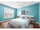 Beautifully staged bedroom with blue walls, neutral furniture, and carpet at 100 Windmeadow Way, Fayetteville, GA 30214