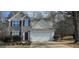 Charming two-story home featuring a two-car garage and a well-maintained front yard at 801 Winbrook Dr, Mcdonough, GA 30253