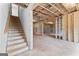 Unfinished basement featuring framed walls and a staircase, presenting a blank canvas for customization and additional living space at 130 Windchime Way # 9, Tyrone, GA 30290