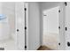 Hallway bathroom with white wall, doors and tiles, and matte black hardware at 130 Windchime Way # 9, Tyrone, GA 30290