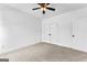 Bright bedroom features neutral carpet, a ceiling fan, and a closet at 130 Windchime Way # 9, Tyrone, GA 30290