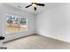 Cozy bedroom with neutral carpet, a ceiling fan, and a large window with a peaceful view at 130 Windchime Way # 9, Tyrone, GA 30290