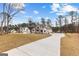 Exterior view of the house, long driveway, and ample yard space at 130 Windchime Way # 9, Tyrone, GA 30290