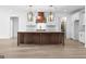 Elegant kitchen island with marble countertops and custom pendant lights at 130 Windchime Way # 9, Tyrone, GA 30290