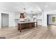 Gourmet kitchen island with a marble countertop, custom cabinets, and stylish pendant lighting at 130 Windchime Way # 9, Tyrone, GA 30290