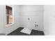 Practical laundry room with tile floor, wire rack shelving, and natural light at 130 Windchime Way # 9, Tyrone, GA 30290