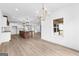 Open-concept living room with hardwood floors, recessed lighting, and a view to the kitchen at 130 Windchime Way # 9, Tyrone, GA 30290