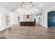 Open-concept layout with white walls, hardwood floors, and kitchen island with stainless-steel appliances at 130 Windchime Way # 9, Tyrone, GA 30290