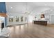 Open-concept layout with white walls, hardwood floors, and kitchen island with stainless-steel appliances at 130 Windchime Way # 9, Tyrone, GA 30290