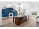 Open floorplan with kitchen island, living room with fireplace, and wood flooring at 130 Windchime Way # 9, Tyrone, GA 30290