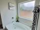 Cozy bathtub area with a plant and a frosted window at 3092 Cedar Crest Way, Decatur, GA 30034