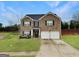Charming two-story brick home with a well-manicured lawn and attached two-car garage at 3092 Cedar Crest Way, Decatur, GA 30034