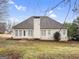 Back exterior view of home with stucco, windows, patio door, and lawn at 9135 Woodhaven Way, Mcdonough, GA 30253