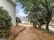 Backyard view with view of neighboring home through trees and landscaping at 9135 Woodhaven Way, Mcdonough, GA 30253