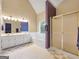 Bright bathroom with double vanity, soaking tub, and glass-enclosed shower at 9135 Woodhaven Way, Mcdonough, GA 30253